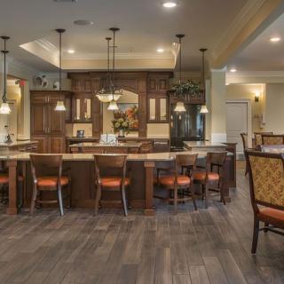 A spacious, traditional-style kitchen with a large island and bar stools.