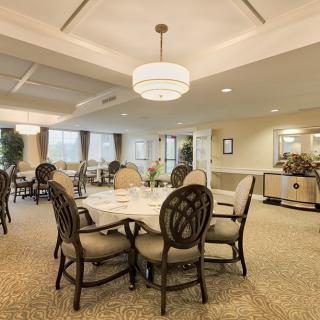 Elegant dining area with round tables and comfortable seating.