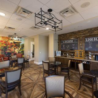 A cozy cafe interior with a seating area and menu board.