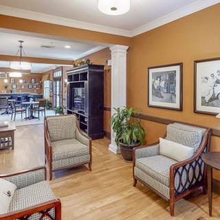 Cozy lounge area with seating and decor in a warm-toned room.