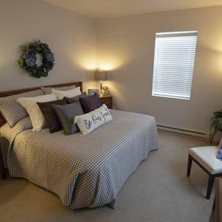 A cozy bedroom with modern decor and neutral tones.