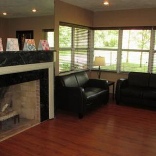 Cozy living room with a fireplace and large windows.