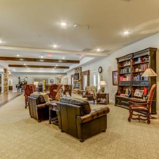 A cozy library with comfortable seating and well-lit bookshelves.