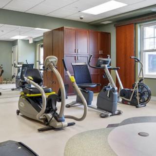 A well-equipped gym with various exercise machines.