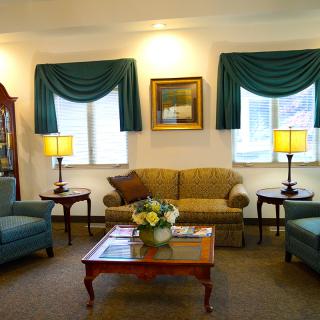 A cozy living room with comfortable seating, coffee table, and elegant decor.