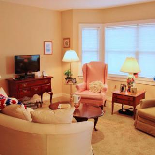 A cozy living room featuring comfortable seating, soft lighting, and a welcoming atmosphere.