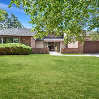 A suburban house with a well-maintained front yard and driveway.