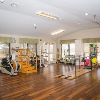 A spacious gym equipped for rehabilitation and fitness activities.