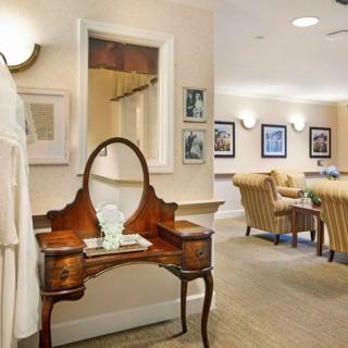 A classic interior with an elegant wooden vanity and a cozy seating area.