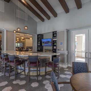 A modern bar and seating area with contemporary furniture and stylish lighting.