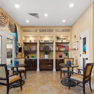 A cozy waiting area with seating, bookshelves, and decorative elements.