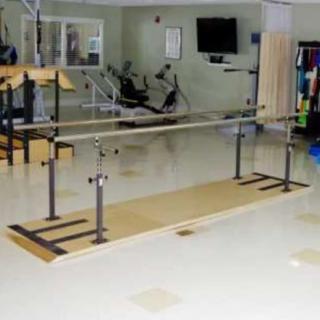 A rehabilitation room featuring balance bars for physical therapy exercises.
