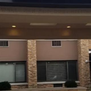 A storefront with brick pillars and illuminated overhead lights.