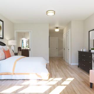 A modern bedroom with stylish furniture and ample natural light.