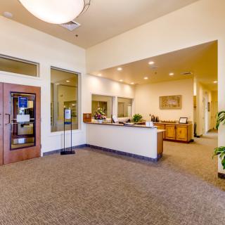 A spacious and well-lit office reception area with modern furnishings.