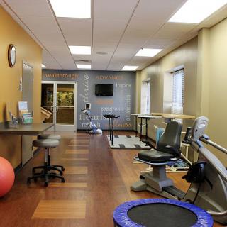 A spacious and well-equipped physical therapy room designed for rehabilitation exercises.