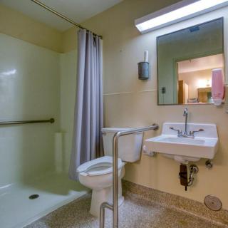 An accessible bathroom with a walk-in shower, grab bars, and a spacious layout.