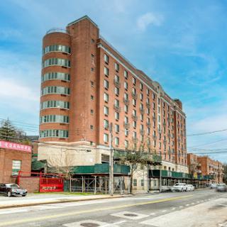 A modern hotel building situated in an urban environment.
