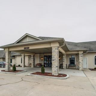 A residential facility with a covered entrance and driveway.