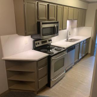 A modern kitchen layout featuring stainless steel appliances and ample cabinet space.
