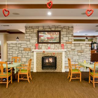 Cozy dining area with a fireplace and Valentine's Day decorations.