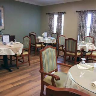 A cozy dining room with neatly arranged tables and chairs.