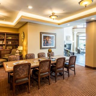 A well-appointed conference room featuring a spacious wooden table and comfortable seating, ideal for meetings and discussions.