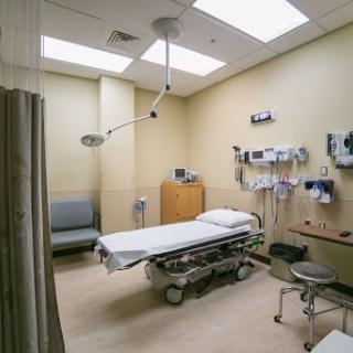 A clean and well-organized examination room in a hospital.