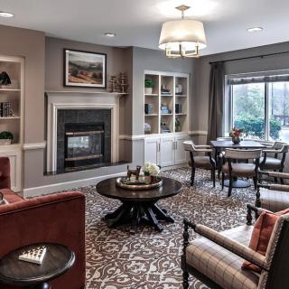A modern living room featuring a cozy fireplace, elegant furniture, and stylish decor.
