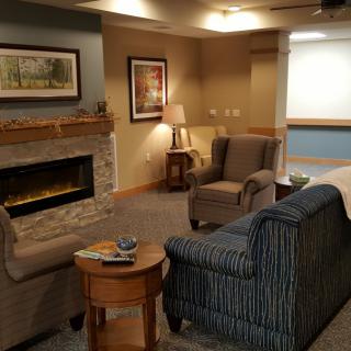 A cozy living room featuring a fireplace, comfortable seating, and tasteful decor.