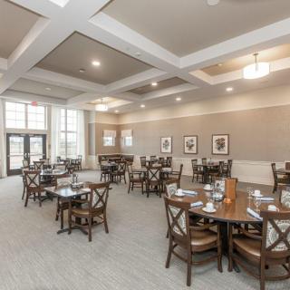An elegantly designed dining area with neatly arranged tables and chairs.