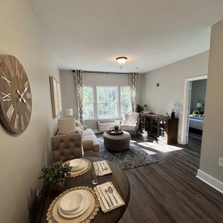 A modern living room and dining area with natural lighting and stylish decor.