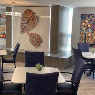 A well-decorated dining area featuring modern artwork and comfortable seating.