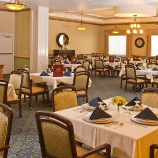 An elegant dining room with neatly arranged tables and chairs, ready for guests.