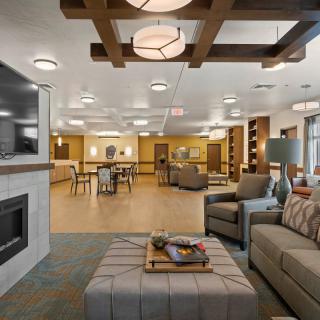 A modern and cozy living room with comfortable seating and a fireplace.
