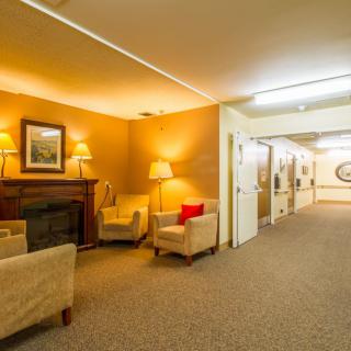 A warmly lit lobby area with comfortable seating and a fireplace.