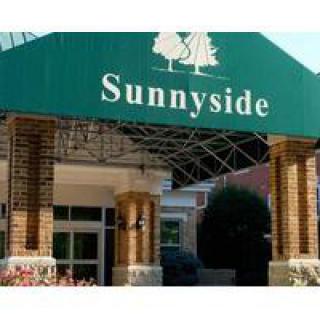 Entrance of the Sunnyside building with a green awning.