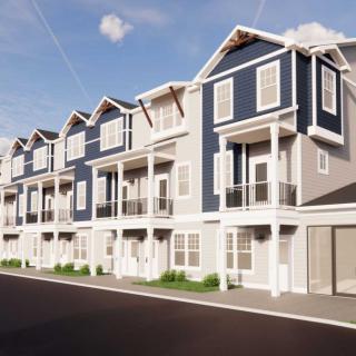 A row of modern townhouses with balconies and garages.