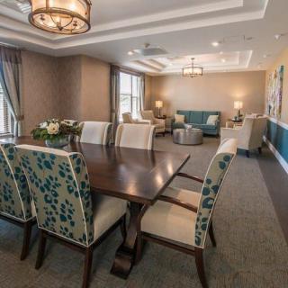 A well-decorated dining and living area with elegant furniture and lighting.