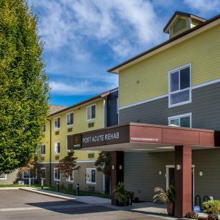 A modern hotel building with a welcoming entrance and neatly maintained surroundings.