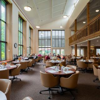 A spacious library with large windows and comfortable seating areas.