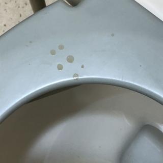 Close-up of a toilet with visible stains.