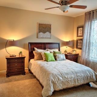 A cozy bedroom with a neatly made bed and stylish decor.