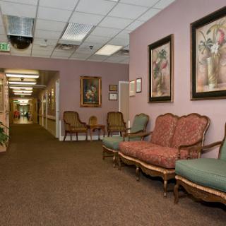 A cozy waiting room featuring vintage furniture and decorative artwork.