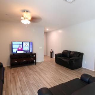 A cozy living room featuring a television and comfortable seating.