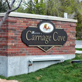Entrance sign for Carriage Cove displayed on a brick structure.