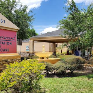 A view of a healthcare facility with well-maintained landscaping and clear signage.