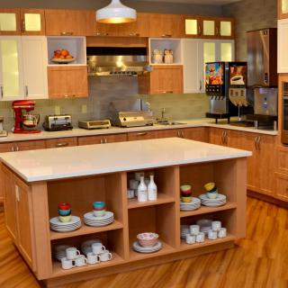 A modern kitchen with a central island and various appliances.