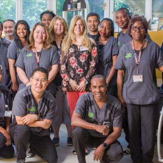 A team of healthcare professionals posing together for a group photo.