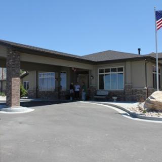 A welcoming residential building featuring a front entrance and an American flag.